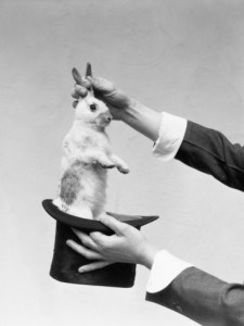h-armstrong-roberts-hands-of-magician-performing-magic-trick-pulling-rabbit-out-of-top-hat